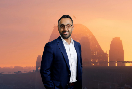 Sam Akram headshot against a background image of the Sydney Harbour Bridge